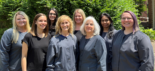 Friendly dental team posing outside