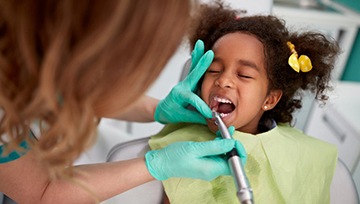 Little girl having her teeth cleaned