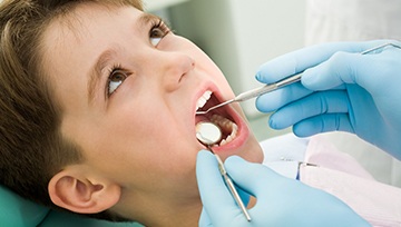 Little boy undergoing a checkup and oral cancer screening