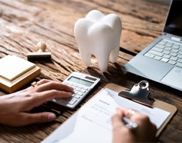 A person filling out a dental insurance form