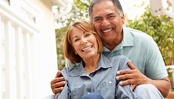 Adult couple smiling together outside