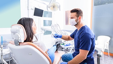 Patient sitting in the dental chair with a dentist nearby