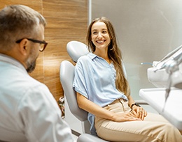 Patient smiling at the dentist while sitting down