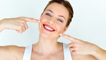 woman pointing to her teeth