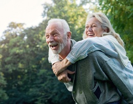 Couple smiling with dental implants in Ann Arbor