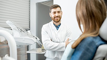 dentist looking inside patient’s mouth 