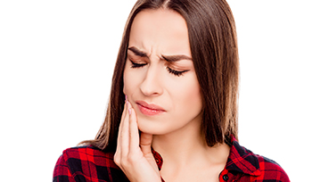 Woman in pain holding her jaw