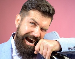 Man opening bottle with teeth