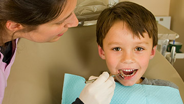 Happy little boy in dental chair