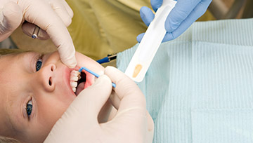 Child receiving fluoride treatment