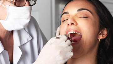 Patient receiving oral cancer screening