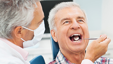 Senior man receiving dental exam