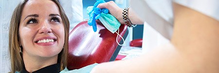 Woman in dental chair smiling at dentist