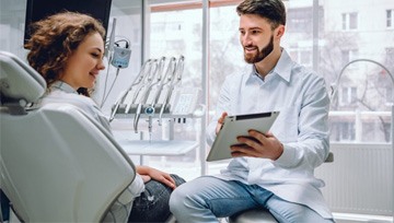 dentist showing a tablet to a patient 