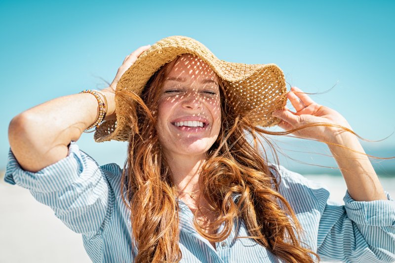 woman smiling after getting cosmetic dental treatments in Ann Arbor