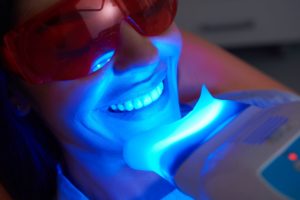 Facial zoom in of woman having teeth whitening at the dentist